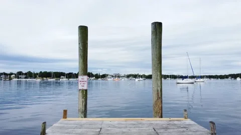 Flying between the docks posts over water Stock Footage 155865462