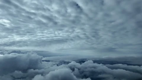 Flying Between Layers of Clouds in a Dramatic Grey Sky: Cockpit View Through Stock Footage 320999073