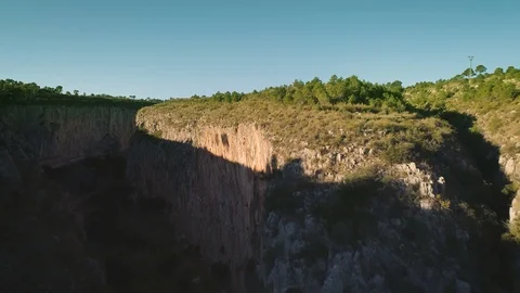 Flying up between mountain rocks canyon towards blue sky. Aerial landscape view Stock Footage 86520648