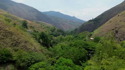 Flying between mountains with drone, Aerial view through mountain valley, Scenic Stock Footage 319860835