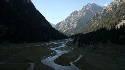 Flying between mountains over the mouth of a mountain river Stock Footage 297315341