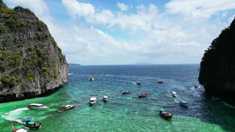 Flying between two mountains, bay, turquoise water, boats and logtails, clear Stock Footage 249451288