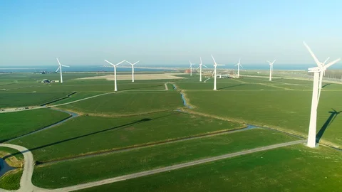 Flying Between Windmills with the Enclosure Dam - Friesland, Holland – 4K Drone Stock Footage 127576173