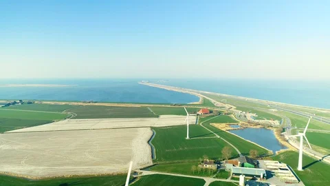 Flying Between Windmills with the Enclosure Dam - Friesland, Holland – 4K Drone Stock Footage 127576275