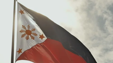 Flying bicolor flag of the Philippines with central golden sun representing the Stock Footage 85959206
