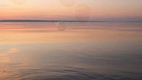 Flying bubbles over the water at sunset. Anti-stress video. Abstract video. Stock Footage 114988298