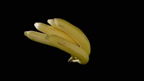 Flying bunch of bananas on a black background. Super slow-motion. Stockbeeldmateriaal 149177388