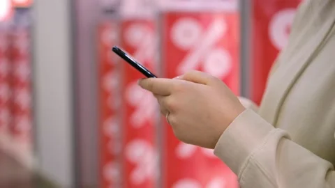Flying the camera around. Red discounts. sale of goods.Girl holding her Stock Footage 169439969