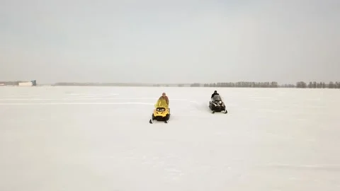 Flying camera captures the movement of snowmobiles in the fields Stock Footage 146630963