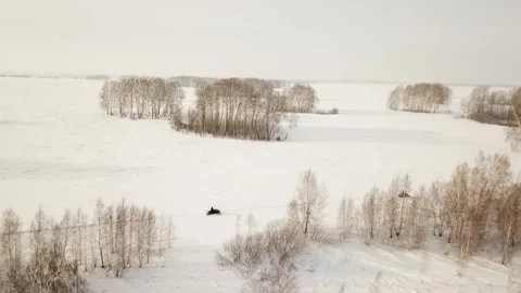 Flying camera captures the movement of snowmobiles in the fields Stock Footage 146630996