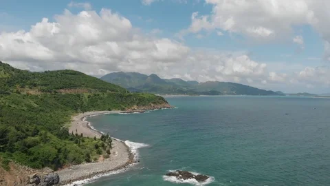 A flying camera flies beautifully over a rocky seashore overlooking  in Vietnam Stock Footage 100190297