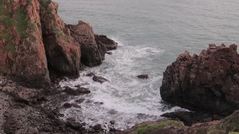 A flying camera flies beautifully over a rocky seashore overlooking Stock Footage 115272364