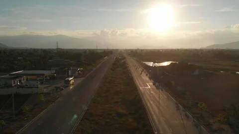 A flying camera flies beautifully a view of the sunset, forest, road Vídeos de archivo 116114182