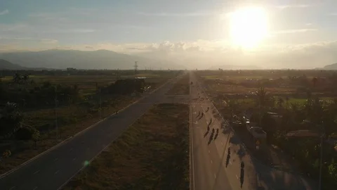 A flying camera flies beautifully a view of the sunset, forest, road Stock Footage 116114666