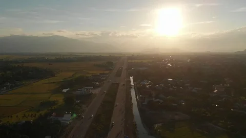 A flying camera flies beautifully a view of the sunset, forest, road Stock Footage 116114928