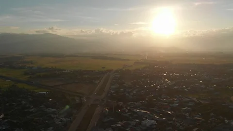 A flying camera flies beautifully a view of the sunset, forest, road Video stock 116115562