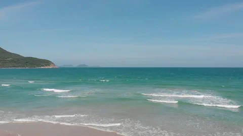Flying camera flies over a beautiful beach overlooking the waves Stock Footage 115724034