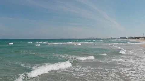 Flying camera flies over a beautiful beach overlooking the waves Stock Footage 115724187