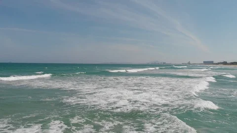 Flying camera flies over a beautiful beach overlooking the waves Stock Footage 115724223
