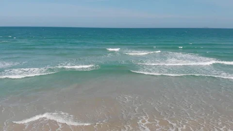 Flying camera flies over a beautiful beach overlooking the waves Stock Footage 115724353