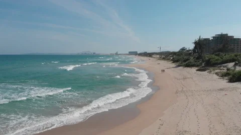 Flying camera flies over a beautiful beach overlooking the waves Stock Footage 115724357
