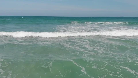 Flying camera flies over a beautiful beach overlooking the waves Stock Footage 115724368