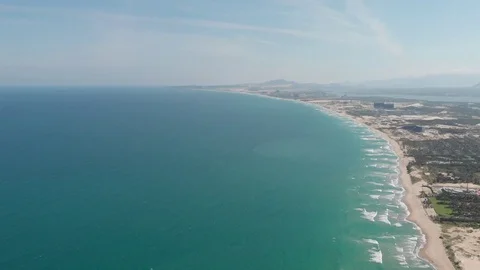 Flying camera flies over a beautiful beach overlooking the waves Stock Footage 115724398