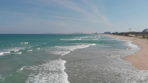 Flying camera flies over a beautiful beach overlooking the waves Stock Footage 115724692