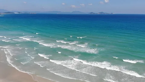 Flying camera flies over a beautiful beach overlooking the waves Stock Footage 116118912