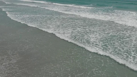 Flying camera flies over a beautiful beach overlooking the waves Stock Footage 116119903