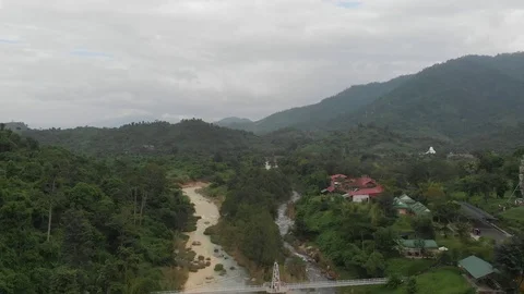 Flying camera flies over the mountains with thick green forests Stock Footage 100190659