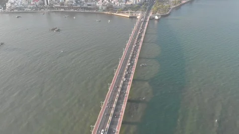 A flying camera flies over a railway bridge stretched across a river Vídeo Stock 117430888