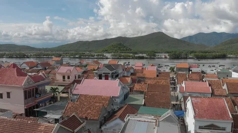 A flying camera flies over the roofs of houses in Vietnam in Khanh Hoa Stock Footage 117441699