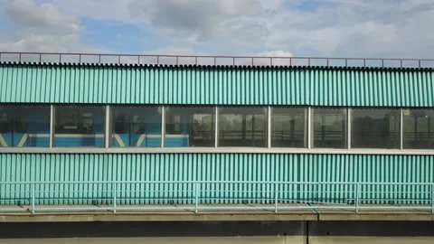 Flying camera flies past the windows of the metro bridge Stock Footage 139036104