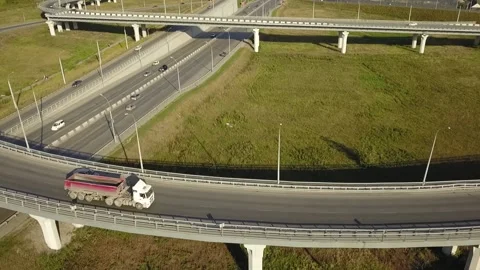 A flying camera monitors the car moving along the overpass Stock Footage 141501102