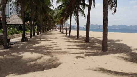 A flying camera over the beach of Nha Trang Vietnam sea island of palm trees Stock Footage 100187517