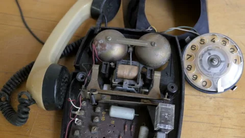 Flying camera over broken rotary dial telephone Stock Footage 96003857