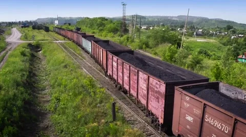 Flying of camera over the composition of the train with coal. 50fps Stock Footage 51639546