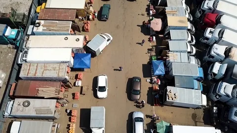 Flying camera over trailers with food on the market with the help of a copter Stock Footage 93449010