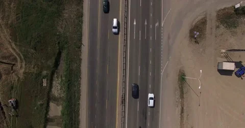 Flying camera rises up over the highway and turns around Stock Footage 56349801
