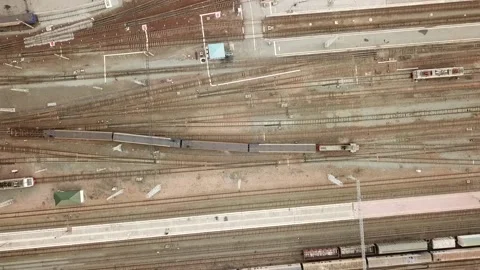 A flying camera shoots an electric train moving through the station Stock Footage 141705513