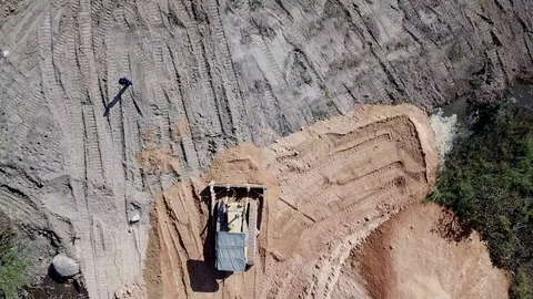 A flying camera shoots how a bulldozer is leveling the road Video stock 123217119