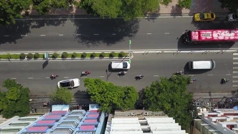 A flying camera shoots a motorcyclist from top to bottom with a view of the road Stock Footage 119555140