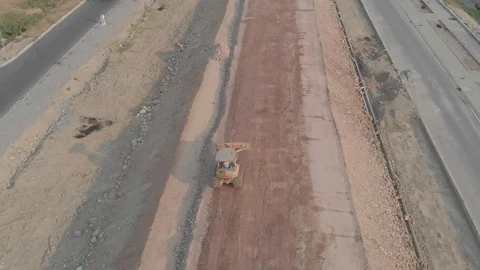 Flying camera shoots a tractor at a construction site in Vietnam Vídeos de archivo 117431029