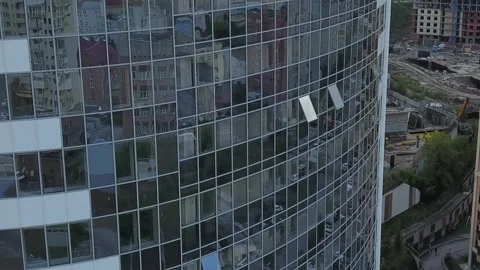 A flying camera shows the windows of a white skyscraper in Russia Stock Footage 139564157