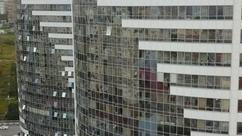 A flying camera shows the windows of a white skyscraper in Russia Stock-Footage 139564232