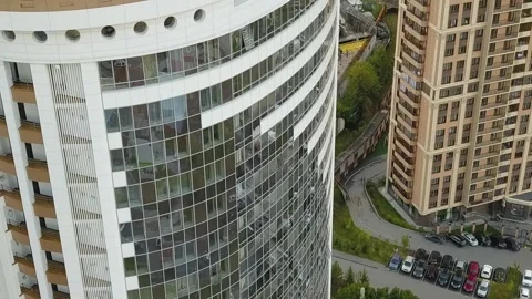 A flying camera shows the windows of a white skyscraper in Russia Stock Footage 139564259