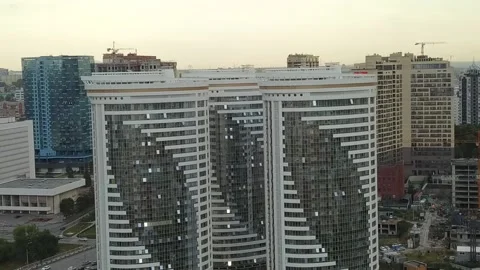 A flying camera shows the windows of a white skyscraper in Russia Stock Footage 139564364