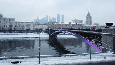 The flying camera slowly flies up to the bridge on which the metro train Stock-Footage 169071665