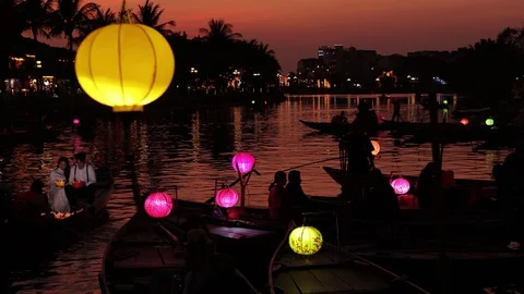 A flying camera takes pictures of luminous boats that sail along the river. Stock Footage 128277489